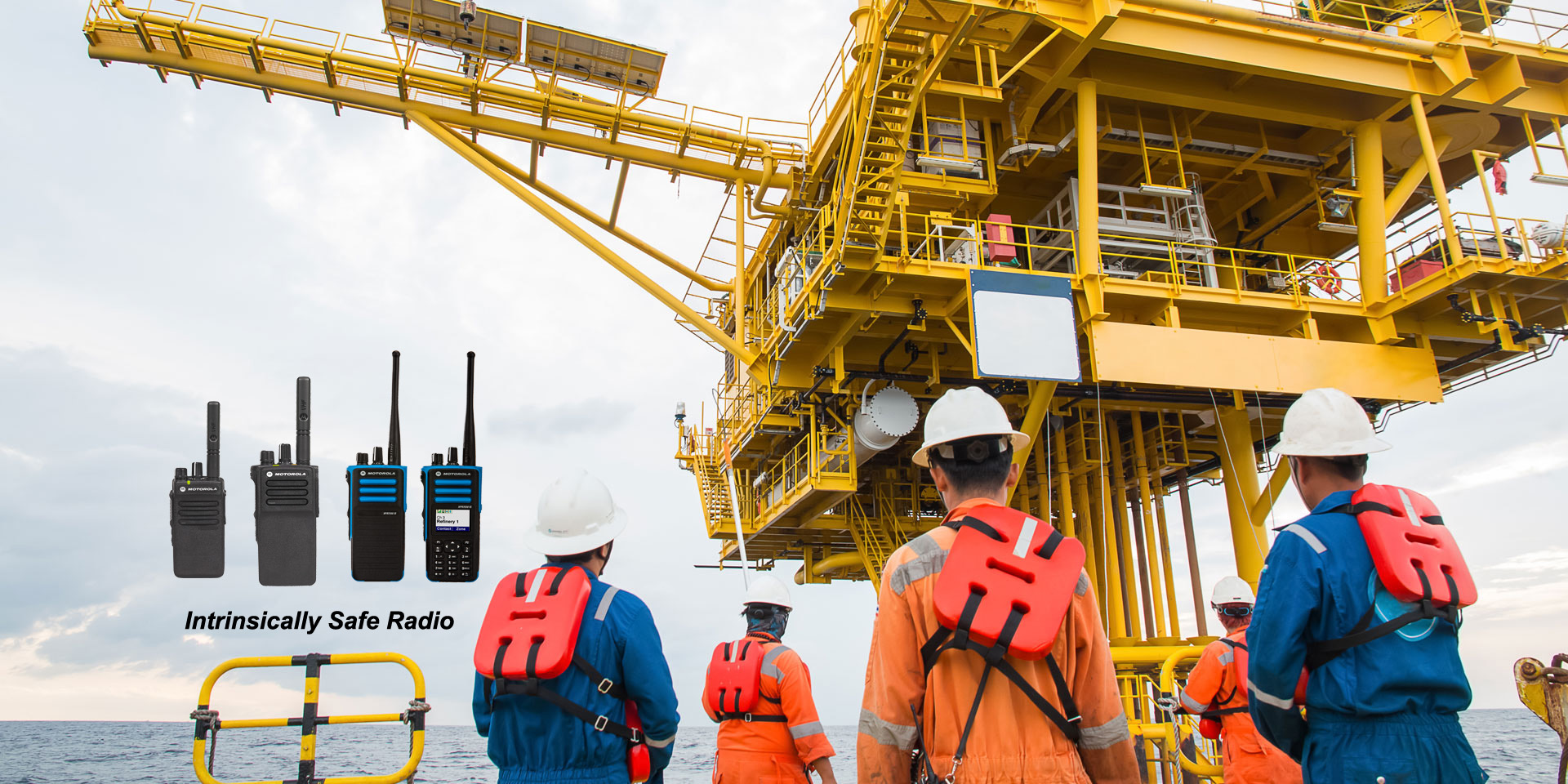 Workers with walkie talkie standing next to an offshore oil and gas plant